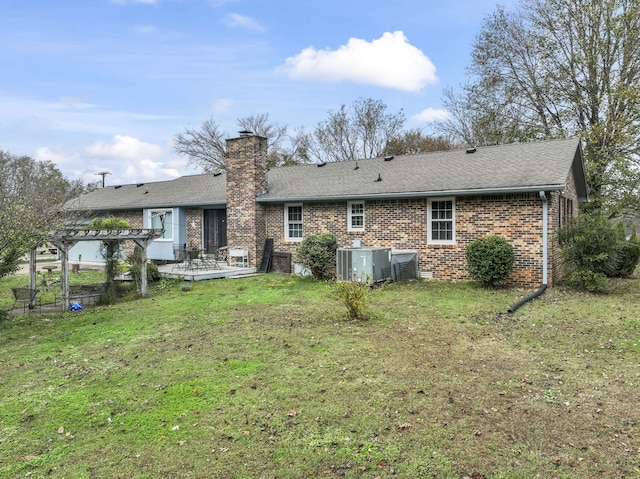 back of house with a pergola and a lawn