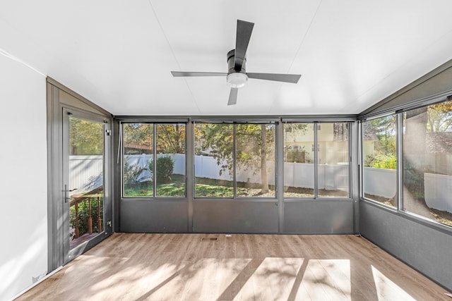 unfurnished sunroom featuring a wealth of natural light, ceiling fan, and lofted ceiling