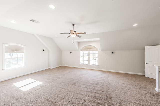 bonus room featuring lofted ceiling, light colored carpet, and ceiling fan