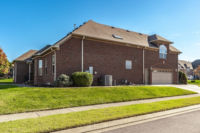 view of side of home featuring a garage, central air condition unit, and a yard