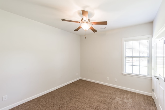 carpeted spare room featuring ceiling fan