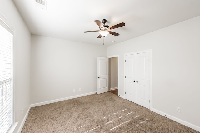 unfurnished bedroom featuring a closet, ceiling fan, and carpet floors