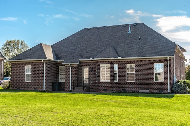 back of property featuring a yard