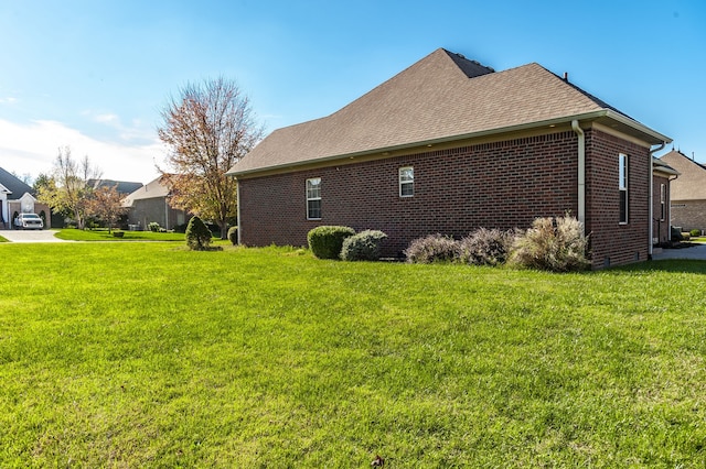 view of side of home featuring a yard