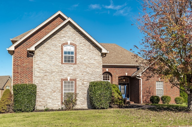 view of property featuring a front lawn