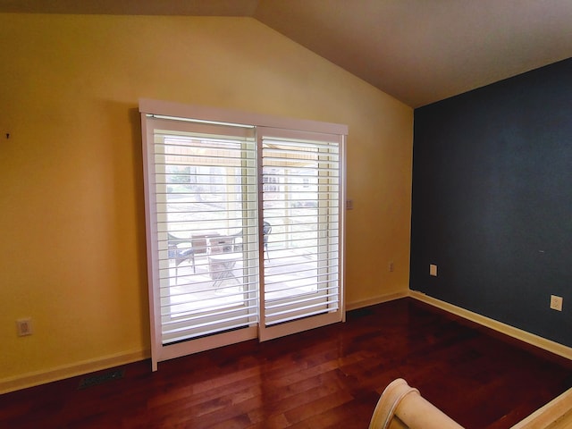 unfurnished room with vaulted ceiling and dark hardwood / wood-style floors