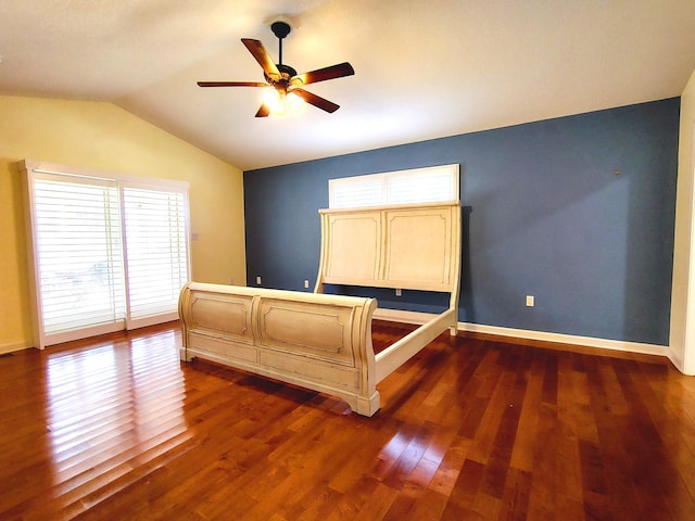 unfurnished bedroom featuring vaulted ceiling, ceiling fan, and dark hardwood / wood-style floors