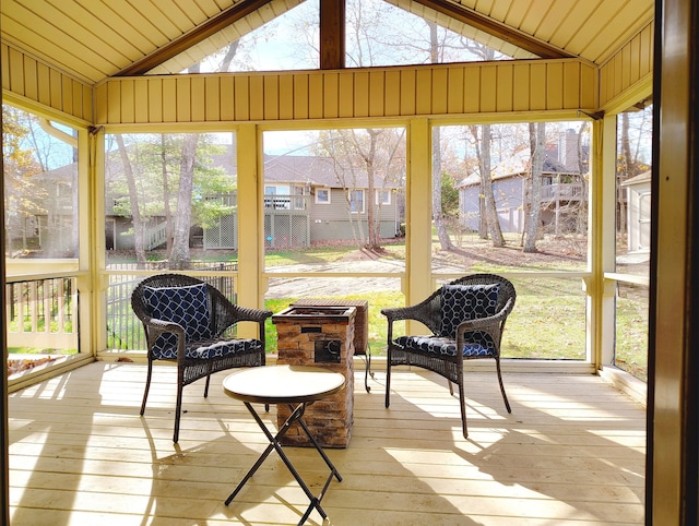 sunroom featuring lofted ceiling and wooden ceiling