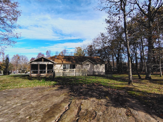 view of front of home featuring a sunroom