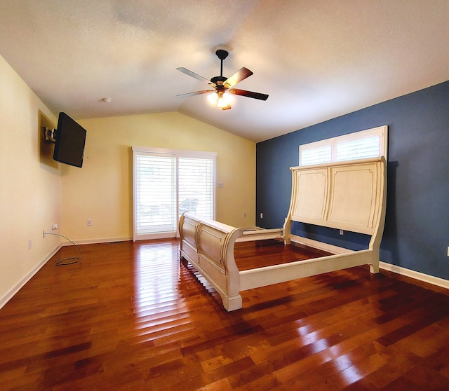 bedroom featuring a textured ceiling, dark hardwood / wood-style flooring, lofted ceiling, and ceiling fan