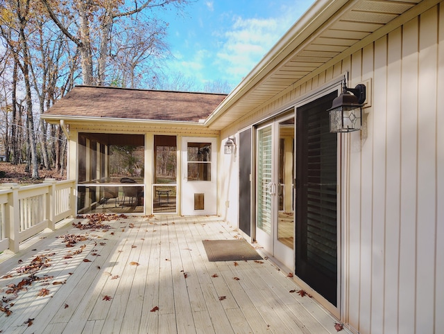 wooden deck with a sunroom