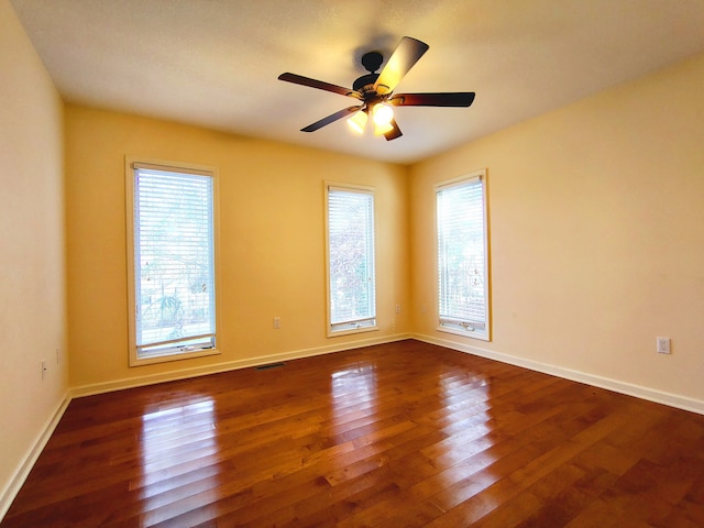 unfurnished room featuring ceiling fan and dark hardwood / wood-style floors