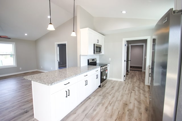 kitchen with stainless steel appliances, light hardwood / wood-style floors, hanging light fixtures, light stone countertops, and white cabinetry