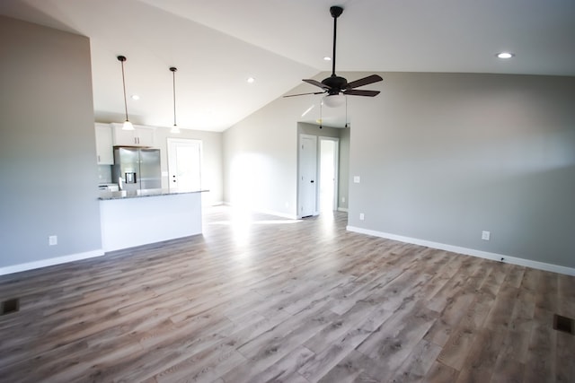 unfurnished living room with ceiling fan, lofted ceiling, and light hardwood / wood-style floors