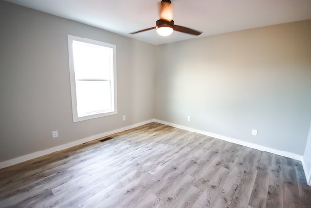 unfurnished room with ceiling fan and light hardwood / wood-style flooring