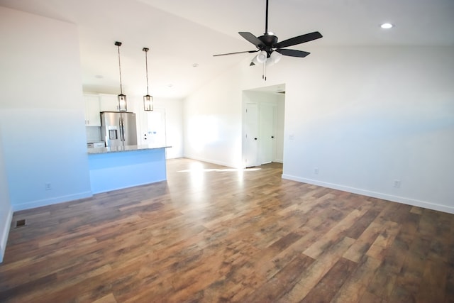 unfurnished living room featuring dark wood-type flooring, ceiling fan, and vaulted ceiling