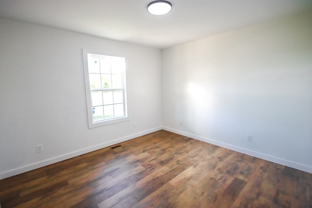 unfurnished room featuring dark hardwood / wood-style flooring