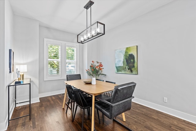 dining room with an inviting chandelier and dark hardwood / wood-style floors