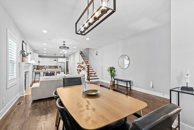 dining space featuring dark hardwood / wood-style floors and a notable chandelier