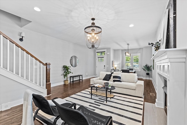 living room featuring hardwood / wood-style floors and an inviting chandelier