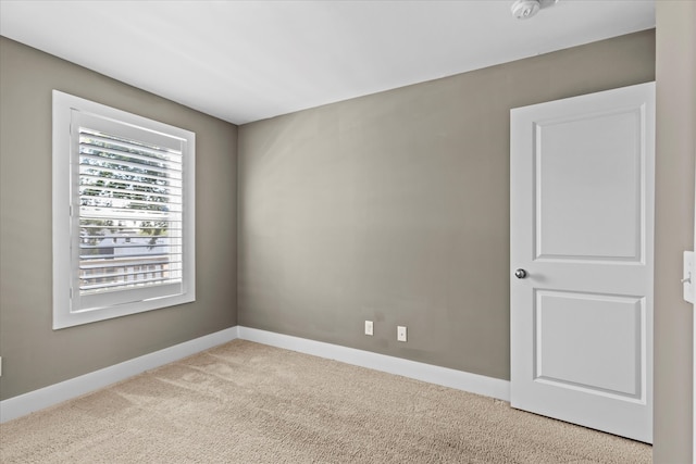 empty room with light colored carpet