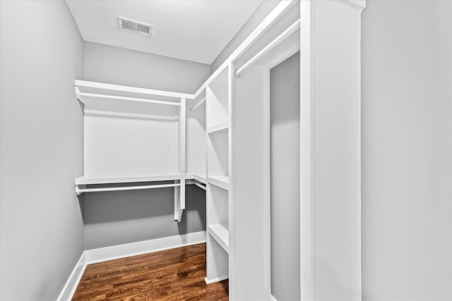 walk in closet featuring dark wood-type flooring