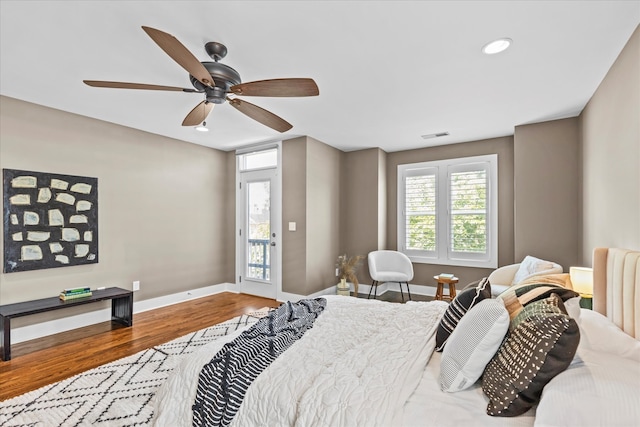 bedroom featuring hardwood / wood-style flooring, access to exterior, and ceiling fan