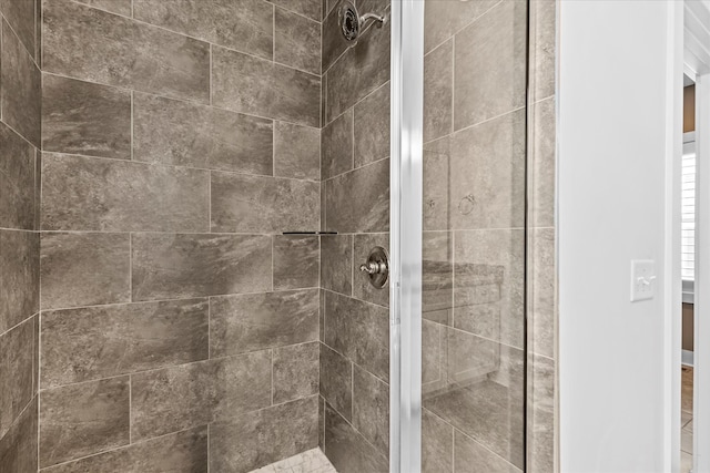 bathroom with tiled shower