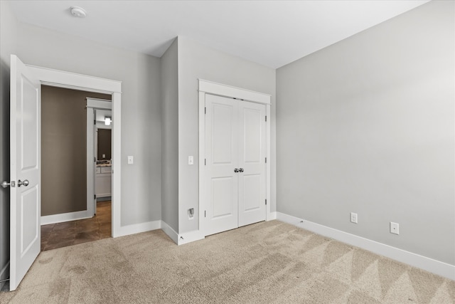 unfurnished bedroom featuring carpet and a closet