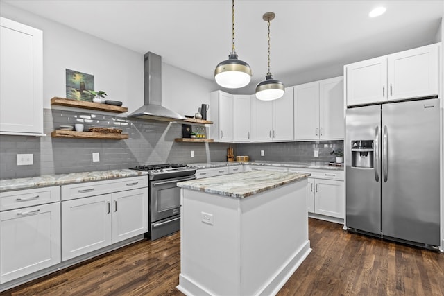 kitchen with white cabinetry, stainless steel appliances, wall chimney range hood, and light stone countertops