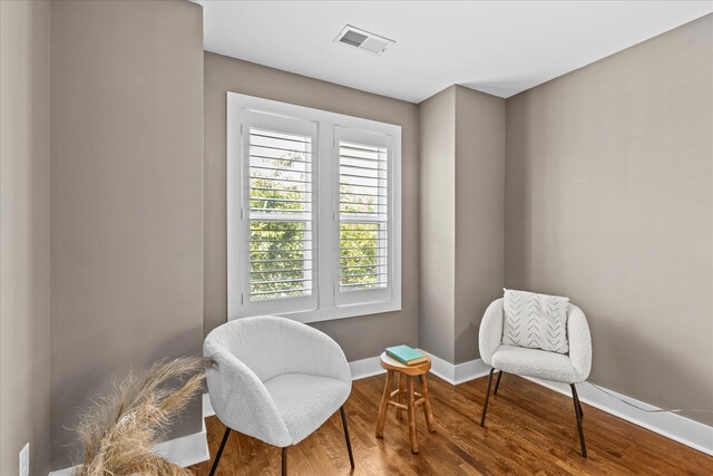 living area with hardwood / wood-style floors