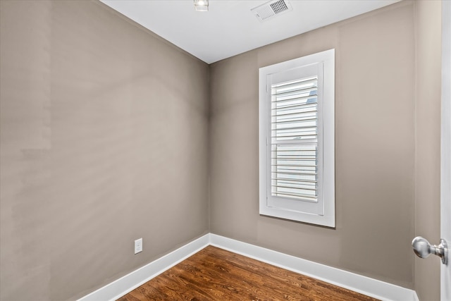 unfurnished room with hardwood / wood-style floors