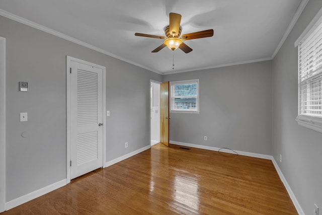 unfurnished bedroom with a closet, ceiling fan, light hardwood / wood-style flooring, and crown molding