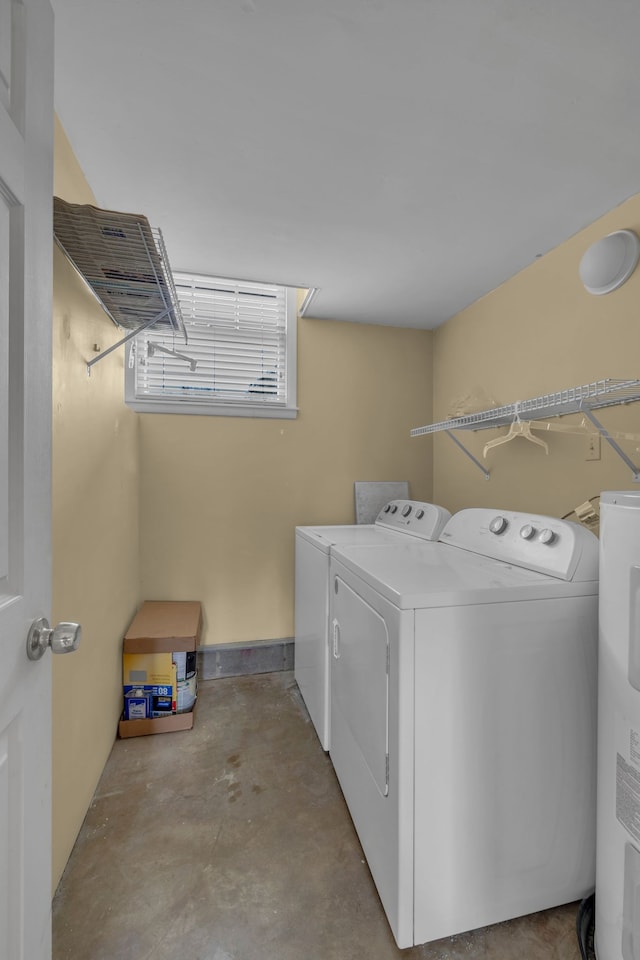 laundry area with separate washer and dryer and water heater