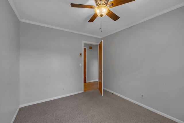 carpeted empty room featuring ceiling fan and ornamental molding