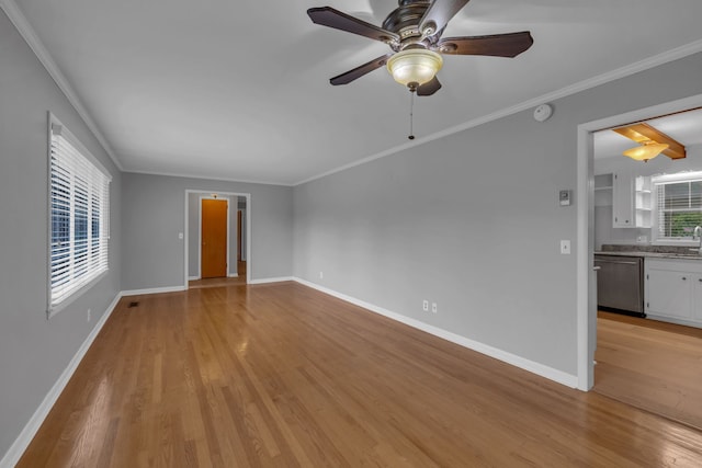 spare room featuring ceiling fan, sink, crown molding, and light hardwood / wood-style flooring