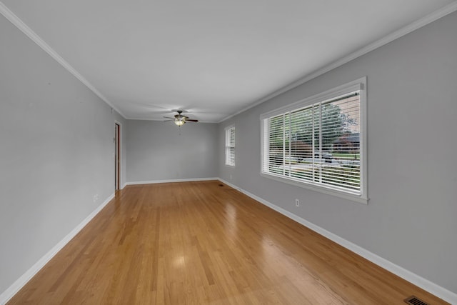 spare room with light wood-type flooring, ceiling fan, and crown molding