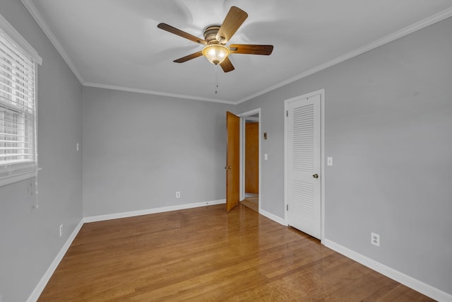 empty room featuring light wood-type flooring, ceiling fan, and crown molding