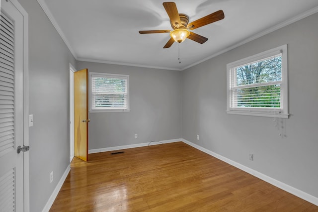 unfurnished bedroom with ceiling fan, light wood-type flooring, and crown molding