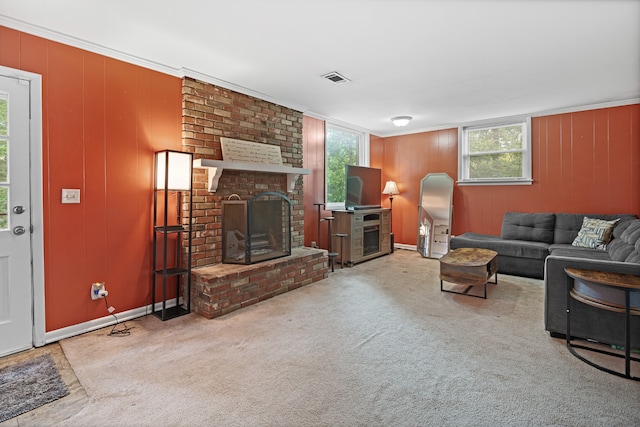 living room featuring light carpet, a fireplace, and ornamental molding