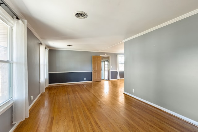 unfurnished room featuring light hardwood / wood-style flooring and ornamental molding