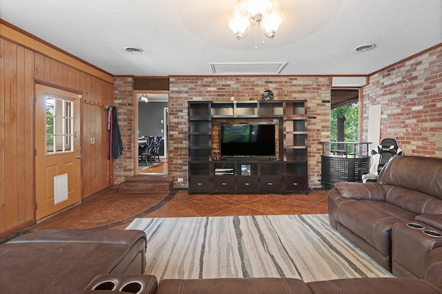 living room with brick wall, tile patterned floors, a textured ceiling, wooden walls, and ornamental molding