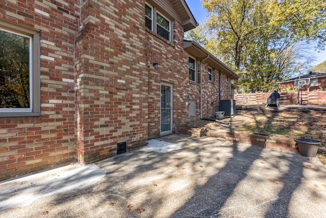 view of side of property featuring a patio area and central air condition unit