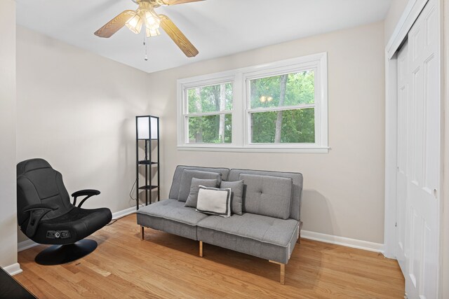 living area featuring ceiling fan and light hardwood / wood-style floors