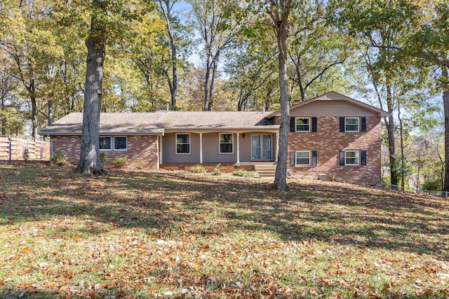 split level home with a front lawn