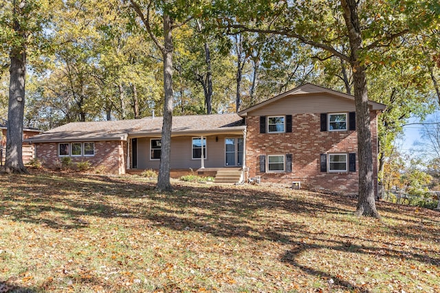 tri-level home with a front yard