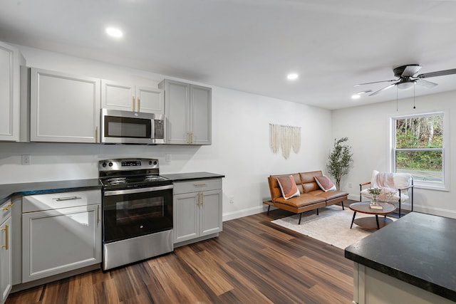 kitchen with gray cabinetry, ceiling fan, stainless steel appliances, and dark hardwood / wood-style floors