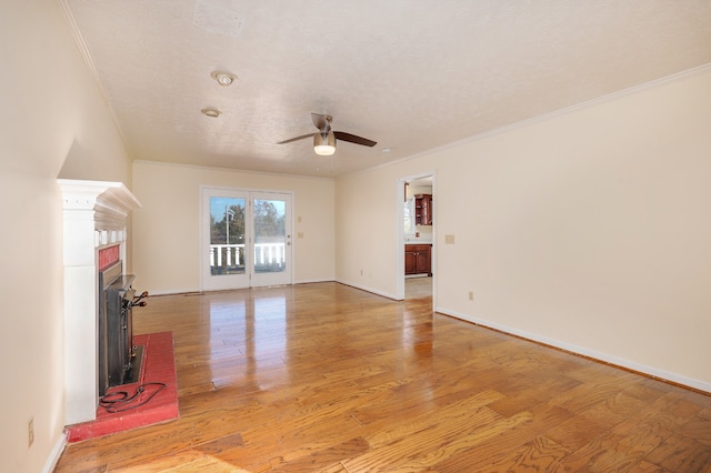 unfurnished living room with light hardwood / wood-style flooring and crown molding