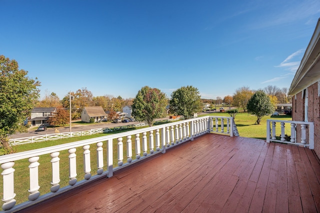 wooden deck featuring a yard