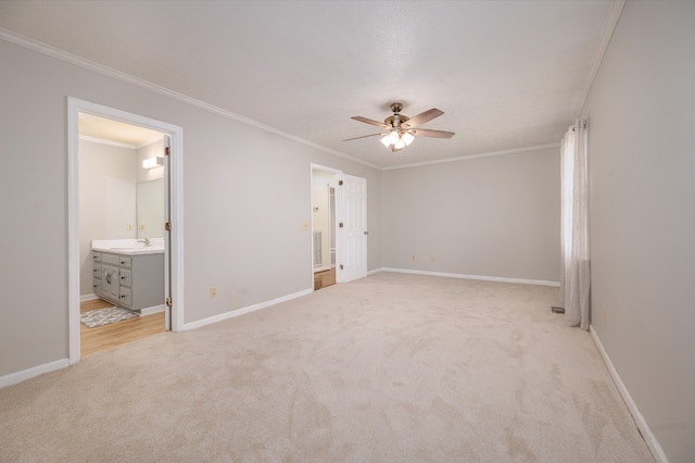 unfurnished bedroom with ensuite bath, light colored carpet, sink, ceiling fan, and crown molding